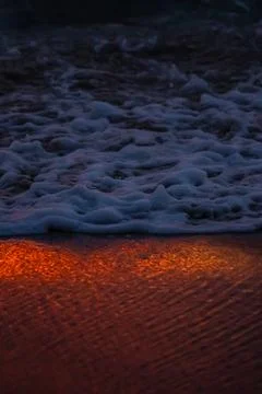 Sunset light reflections on ocean surface with vivid orange tones Stock Photos