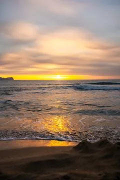 Sunset light reflections on ocean surface with vivid orange tones Stock Photos