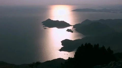 Sunset light reflects across Aegean islands near Fethiye, Turkey - Golden Water Stock Footage 339754877