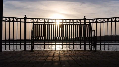 Sunset Light Slider Shot Through Fence and Bench on Pier Stock Footage 236417884