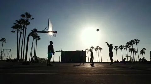 Sunset light, slow motion. Basketball players training exercising outdoors in LA Stock-Footage 131796250