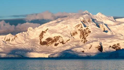 Sunset light on snow-capped mountains and glaciers, Antarctic Peninsula Stock Photos