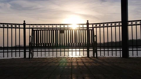 Sunset Light Through Fence and Bench on Lake Slow Motion Stock Footage 236417880