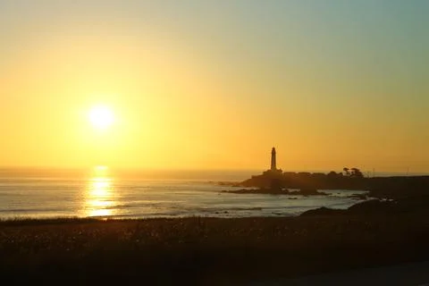The sunset with the lighthouse Stock Photos