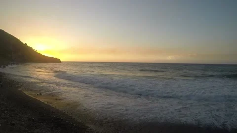 Sunset at a little rough beach Video stock 148985044