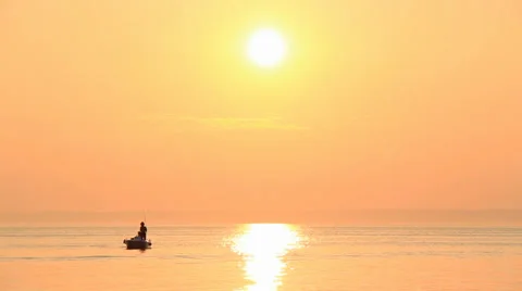 Sunset lone boat under the beautiful sea ocean golden sun horizon Stock Footage 33306691