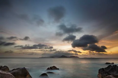 Sunset long exposure with view to Praslin from La Digue, Seychelles with gran Stock Photos