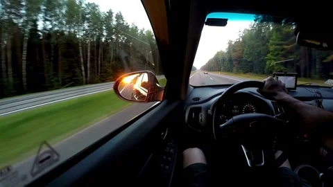 Sunset looking out the window inside a car, driving dashboard and steering Stock-Footage 336267979