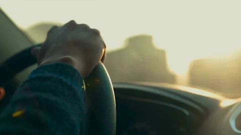 Sunset looking out the window inside a car, driving dashboard and steering Stock-Footage 336268065