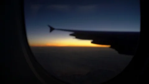 Sunset looking out of Window Plane Handheld Video stock 127034311