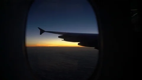 Sunset looking out of Window Plane handheld Video stock 127034585