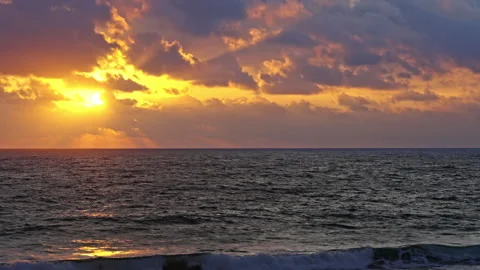 Sunset with lots of clouds and reflections in the ocean Stock Footage 264943628