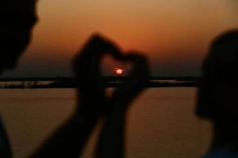 Sunset lovers heart Stock Photos