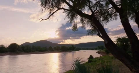 Sunset low aerial pull over river, Samburu National Reserve, Kenya Video stock 245231203