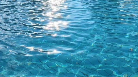 Sunset magic: water in the pool shimmers under the rays of the setting sun Stock Footage 269504862