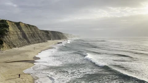 Sunset at Magoito Beach with Cliffs and Waves Stock Footage 314946148