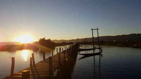Sunset at Maing Thauk Bridge, sun descends on hills, electric poles, Inle Lake Vídeos de archivo 79973428