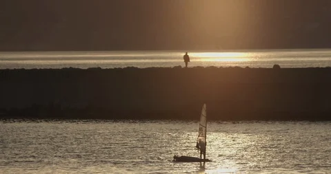 Sunset Man Sailboat Stock Footage 128525949