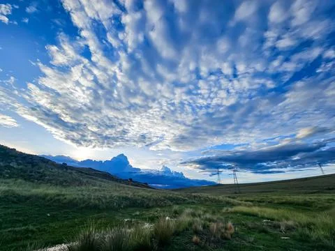 Sunset with many attractive clouds and natural grass Stock Photos