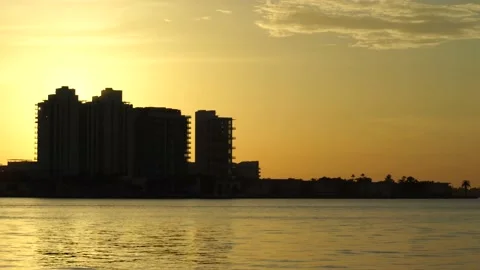 Sunset in Miami Beach with orange and calmed sky and almost sihlouettes of b 스톡 동영상 135355318