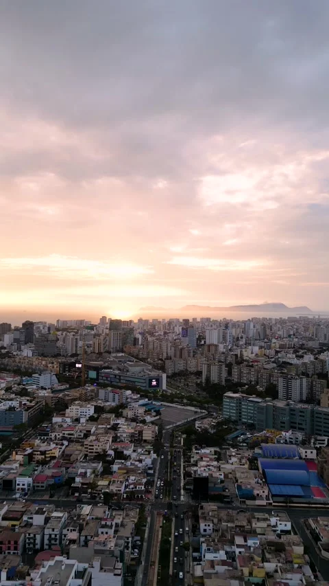 Sunset in the middle of a large and busy city, with the orange sky and clouds Stock Footage 295800481