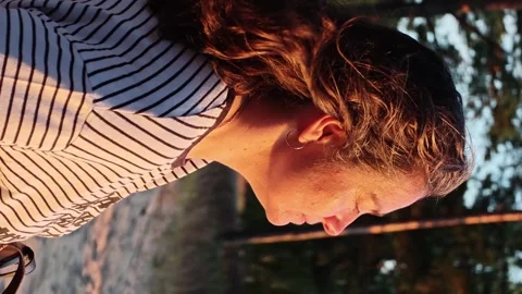 Sunset moment with a 45-year-old woman with long hair in the park, looking Stock Footage 341411011