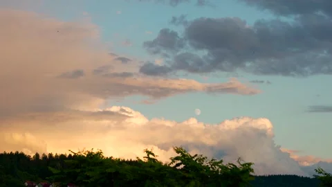 Sunset with the moon visible in the blue sky Stock Footage 313889683