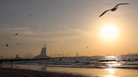 Sunset motion lapse on beach with sea waves silhouettes of people Stock Footage 308880685