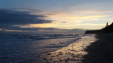 Sunset motion time-lapse of tide on beach in Alaska Stock Footage 102384097
