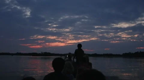 Sunset on a motorized canoe Stock Footage 41857173