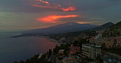 Sunset on Mount Etna, aerial view of the touristic city of Taormina Stock Footage 233432035