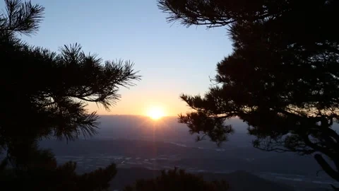 A sunset on the mountain and trees Video stock 303392554