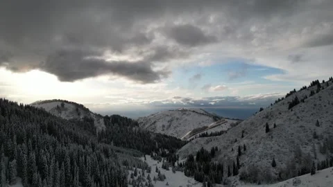 Sunset, mountain clouds and blue sky, a bird's-eye view of the winter mounta Stock Footage 242864245