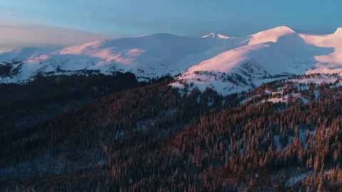 Sunset mountain drone, snowy forest panorama, cinematic alpine scene Video stock 310373359