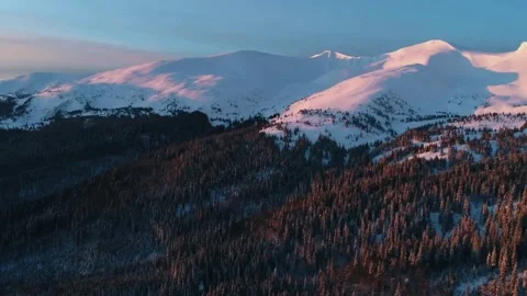 Sunset mountain drone, snowy forest panorama, cinematic alpine scene Stock Footage 310384969
