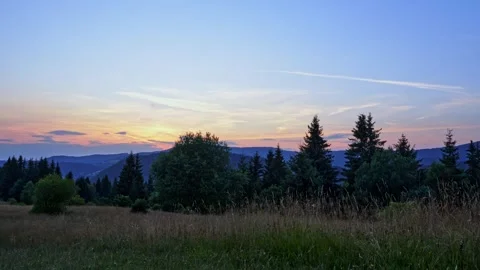 Sunset in the mountain forest landscape in summer, pastel color of the sky 動画素材 247112890