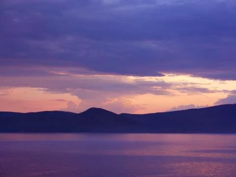 Sunset on mountain lake Stock Photos