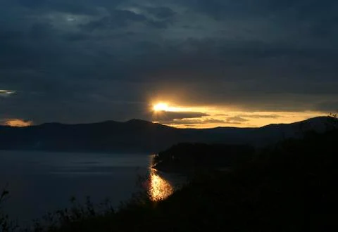 Sunset on mountain lake Stock Photos