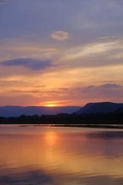 Sunset mountain lake reflection sky landscape golden water creates peaceful.. Stock Photos