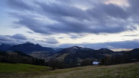 Sunset mountain landscape with dramatic moving clouds time lapse Stockbeeldmateriaal 336395499