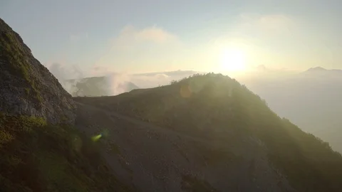 Sunset with mountain peaks. Mountains covered forest, trees and blue sky with Stock Footage 114884659