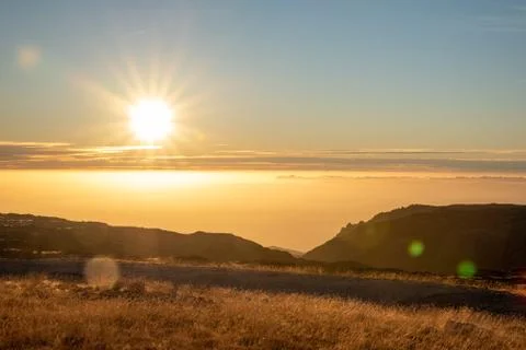 Sunset on the mountain with a ray of sun Stock Photos