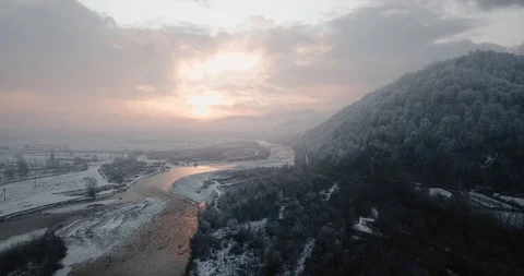 Sunset mountain river snow tree in snow flying drone 動画素材 122602139