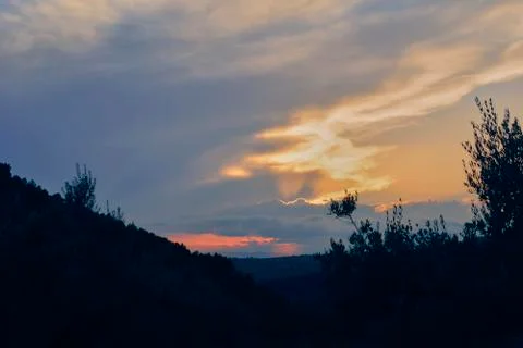 Sunset in mountainous landscape with forest Stock Photos