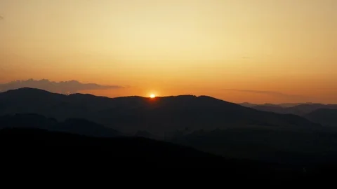 Sunset at mountainous landscape. Sun drops below horizon. Video stock 121371199