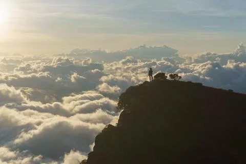 Sunset in the mountains above the clouds Stock Photos