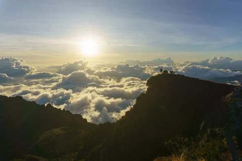 Sunset in the mountains above the clouds Stock Photos