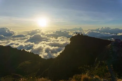 Sunset in the mountains above the clouds Stock Photos