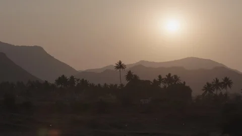 Sunset on mountains and palm trees in India Stockbeeldmateriaal 87915321