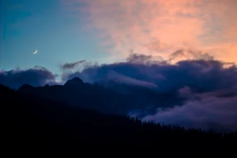 Sunset in the mountains with cloud and moon Foto stock